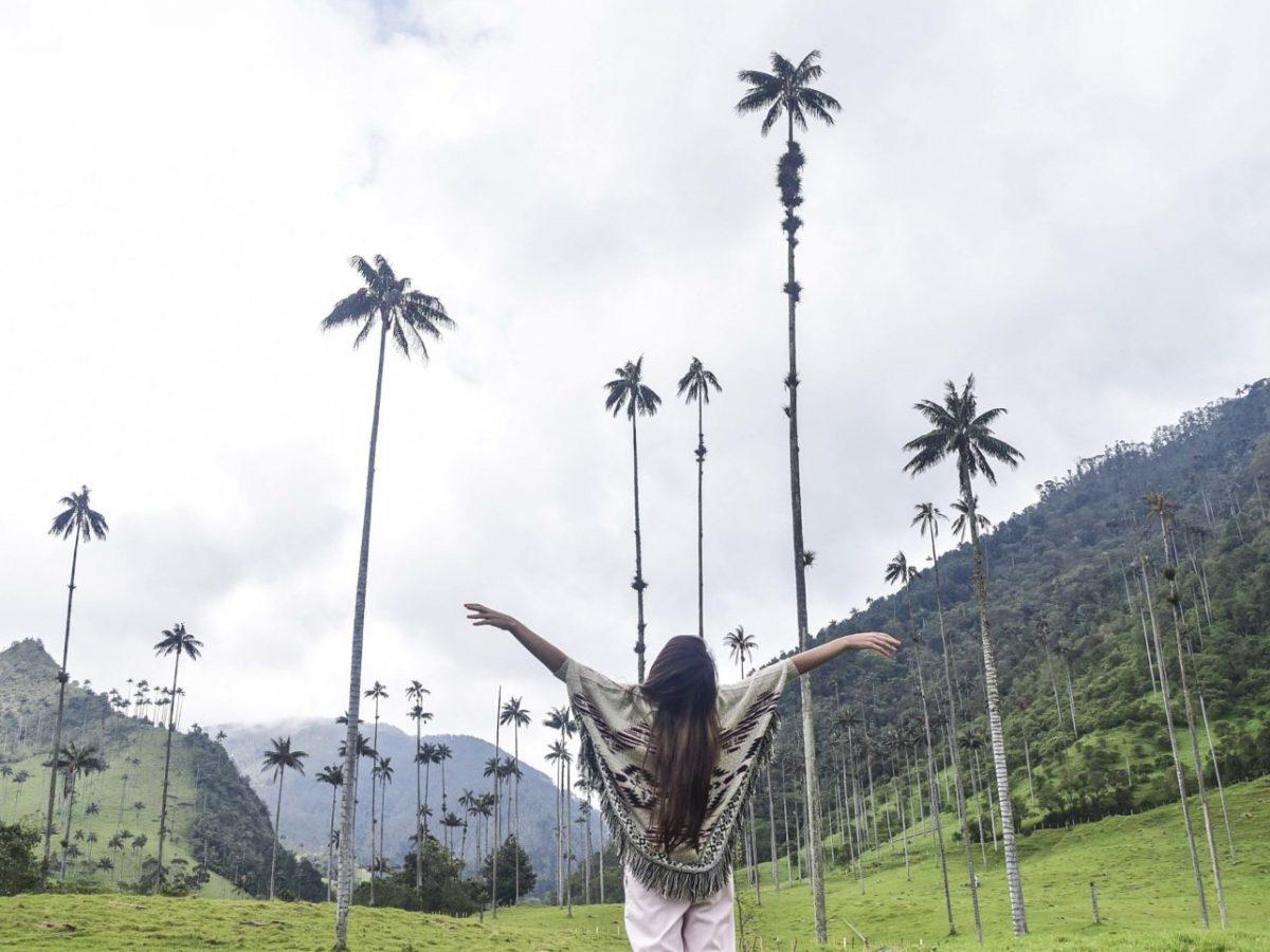 Mujer alzando las manos en el Bosque de Palmas del Valle de Cocora